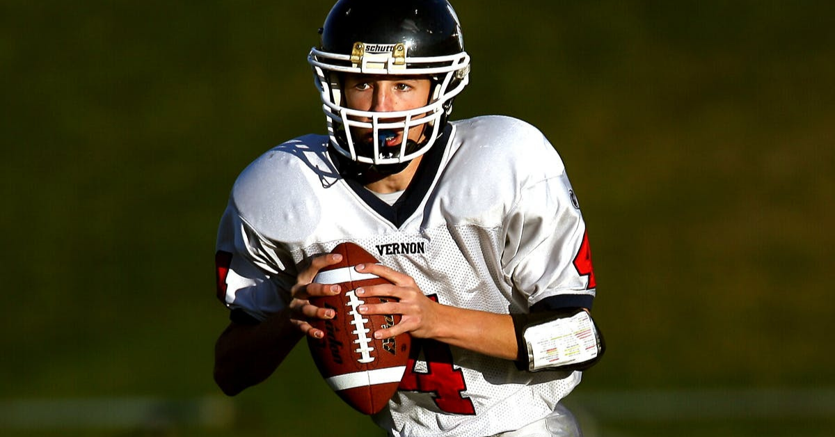football player wears mouthguard with braces